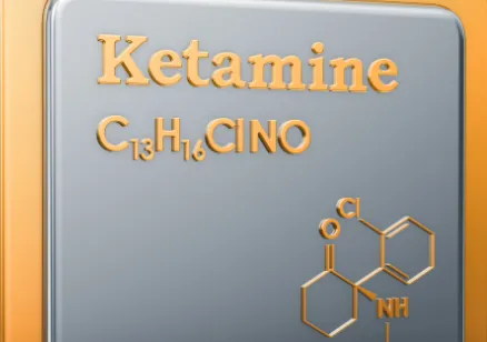 Standing gold tablet with "ketamine" and its molecular formula stamped onto it