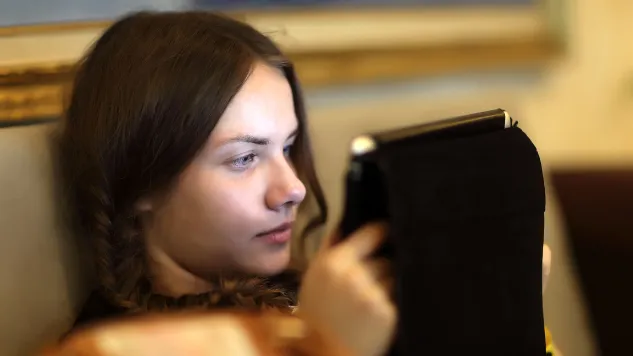 Teen girl watching tablet screen