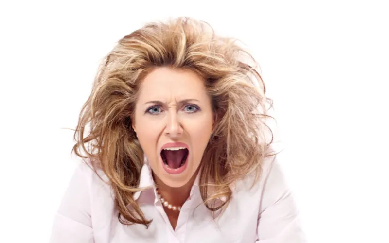 Crazy-haired white woman wearing pearls, screaming