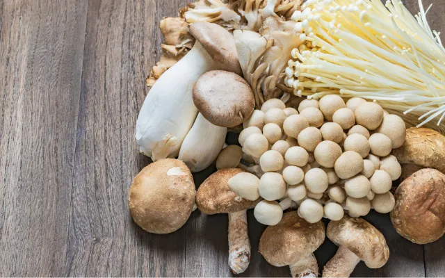 Cornucopia of wild mushrooms on wood table