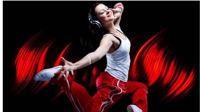 Young woman wearing headphones dancing by herself