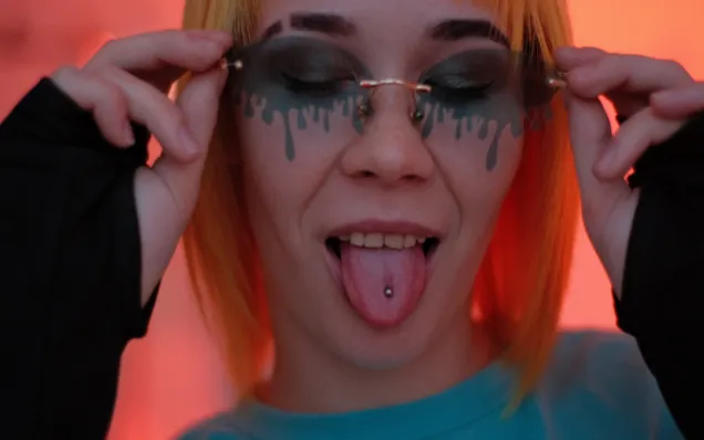 Borderline woman with dyed hair, facial tattoos, and tongue piercing